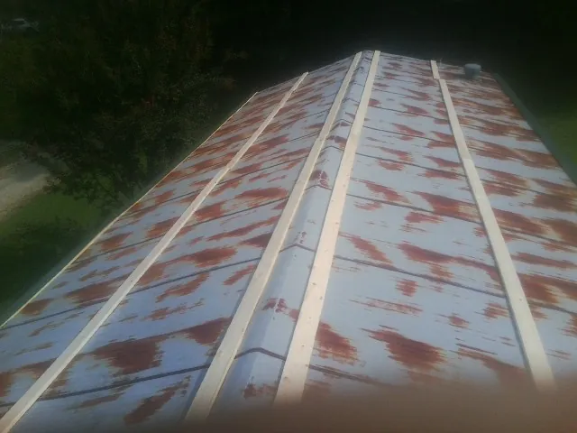 Rusted metal roof panels with new wood purlins before replacement — Storm Damage Roof Repair in La Verkin by Roofing Brothers