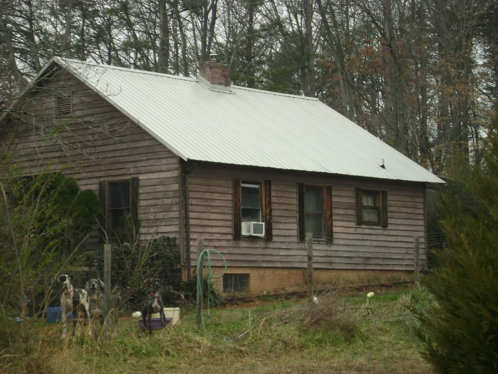 White metal roof on an old wood sided farmhouse, from a Metal Roof Installation job in La Verkin